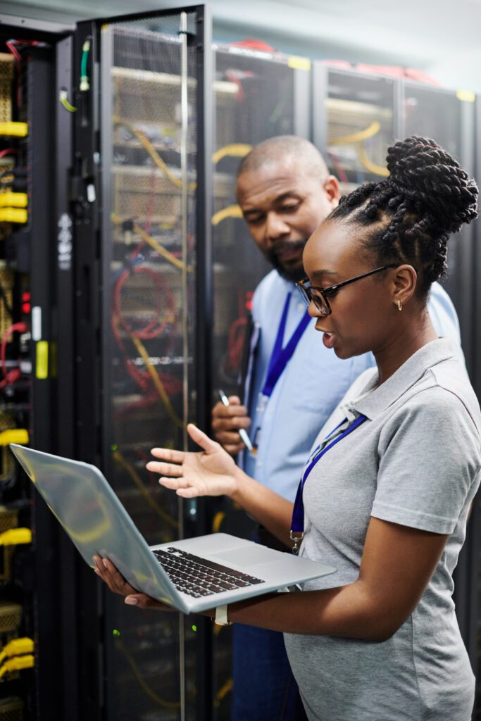 Two Technicians Working In The Server Room