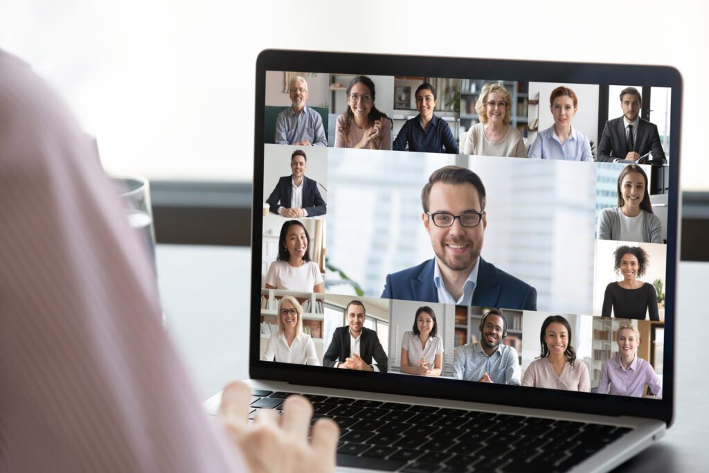 Close Up Of Employee Talk On Video Call On Laptop With Diverse Colleagues